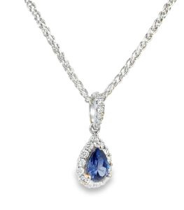 Pear shaped sapphire pendant in white gold set with a halo of VS clarity white diamonds