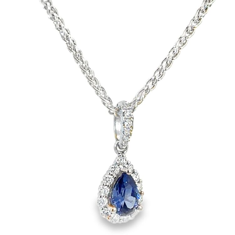Pear shaped sapphire pendant in white gold set with a halo of VS clarity white diamonds